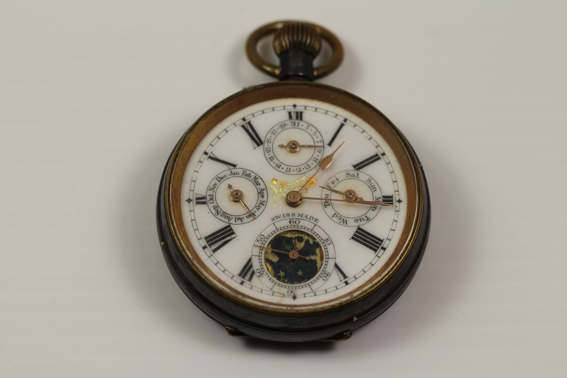 A Swiss perpetual chronograph moon phase pocket watch with white enamel dial,