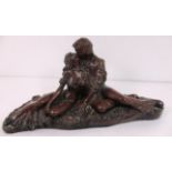 A Bronze resin figure group of a pair kissing,