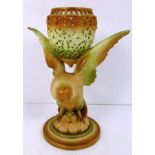 A Royal Worcester pierced vase supported upon a bird of pray base and circular foot,