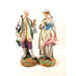 A pair of 19th Century bisque figurines of a lady and gentleman,