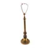 A large early 20th Century Brass table lamp with fluted and ornately cast decoration on wide