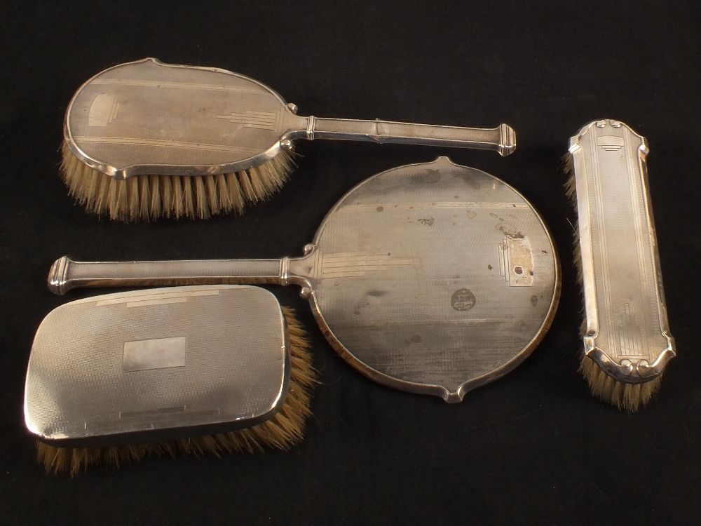 A Silver four piece brush and mirror set (as found)