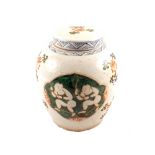 A 19th Century Chinese ginger jar painted with two boys on a green scale background and floral