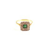 An 18ct Gold Emerald and Diamond cluster ring (damage to Emerald)