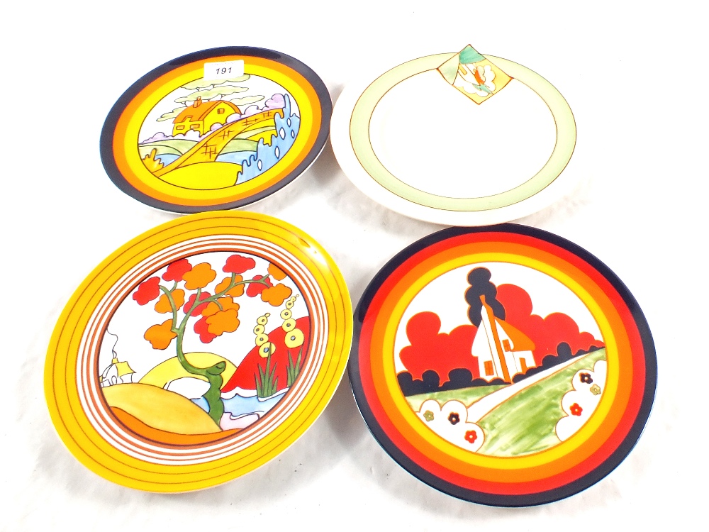 A Clarice Cliff plate plus three Wedgwood copies and a Christmas catalogue