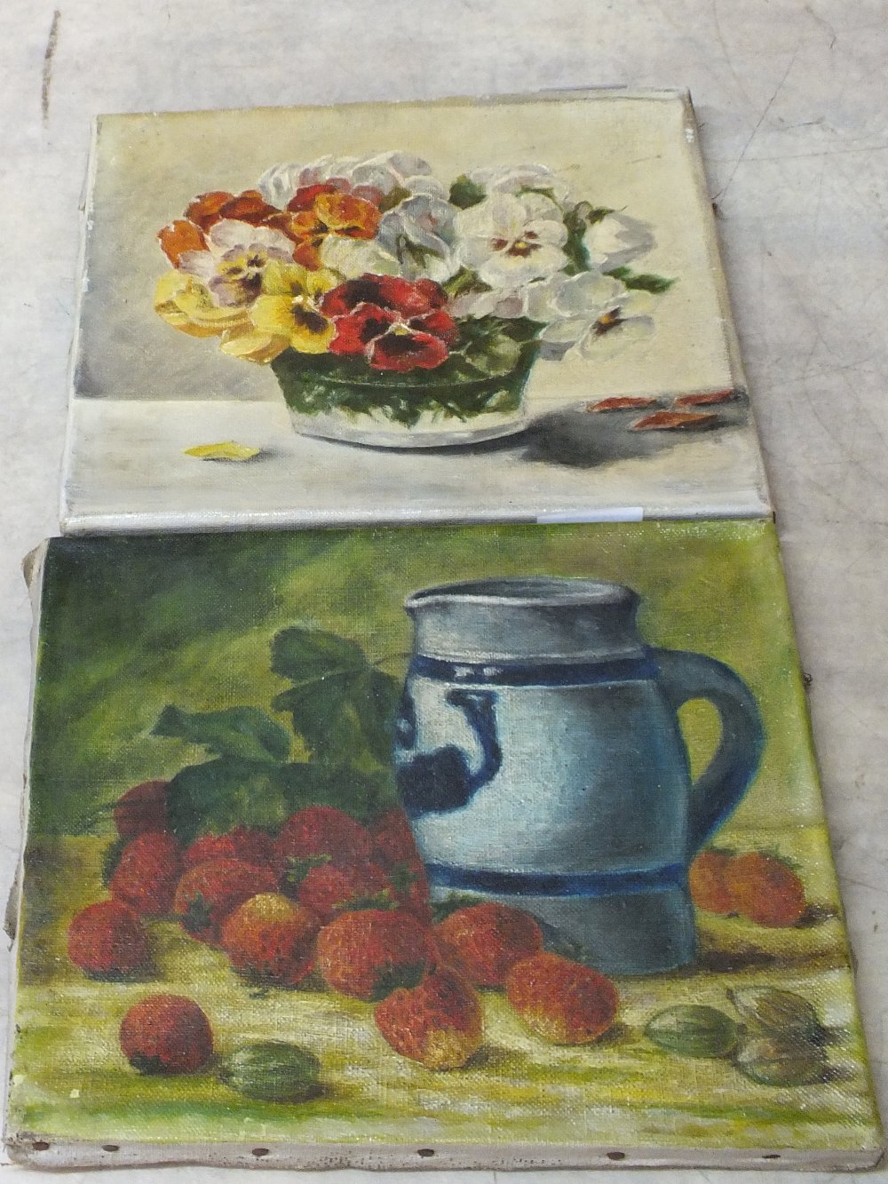 Two unframed paintings on canvas, one fruit the other flowers,