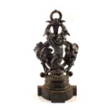 A Victorian cast iron doorstop in the form of a cherub figure amongst fruiting vines on a shaped