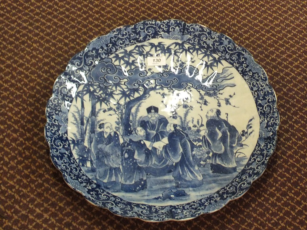 A Japanese blue and white figure decorated shaped edge charger,