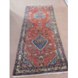 A Persian floral runner with two central medallions,