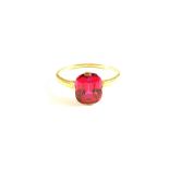 A continental Gold ring set with red stone,