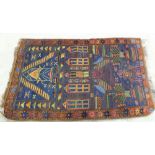 A Persian rug with stylised house design,