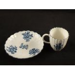 A Lowestoft blue and white ribbed cup and saucer with floral decoration, green overglaze mark