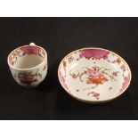 A Lowestoft polychrome cup and saucer with floral basket pattern decoration and pink scale reserve