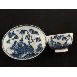 A Lowestoft blue and white tea bowl and saucer with pagoda and fisherman decoration,