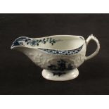 A Lowestoft blue and white relief moulded Hughes style cream boat with chinoiserie decoration,