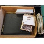 A deed box containing various postcards,