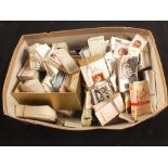 A shoebox of various cigarette cards