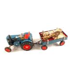 A tin plate tractor, truck with key in truck one spare, one pick, one sack corn,