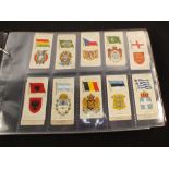 An album of cigarette cards (some full sets) of military related subjects including uniforms and