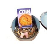 A tub of mixed world coins and books