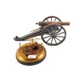 A model of a 19th Century Artillery field gun with a model of a Naval gun on Brass stand