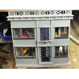 A large wooden dolls house and furniture