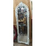 An ornately carved floor standing cheval mirror