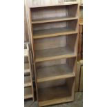 A modern pine five shelf bookcase