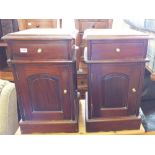 A pair of mahogany bedside cabinets with single drawer and cupboard below