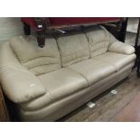 A modern cream leather three seater settee