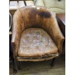 A mahogany framed leather and brass studded tub chair