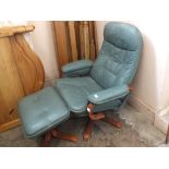 A pair of modern green leather revolving armchairs and a pair of stools