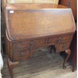 A walnut bureau with unusual curve shaped back,