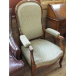 A Victorian mahogany spoonback armchair on cabriole legs with cream and green tapestry upholstery