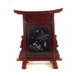 A Japanese maroon lacquer fire screen with black lacquer and Mother of Pearl geishas and rickshaw