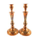 A pair of 19th Century Copper originally Silver plated candlesticks with gadrooning and circular