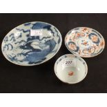 An 18th Century Chinese blue and white saucer dish with four claw dragon decoration plus a red and