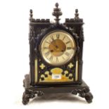 A 19th Century striking mantel clock in black metal architectural case