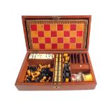 A 19th Century Mahogany games compendium containing chess, dominoes, draughts, crib board, dice,