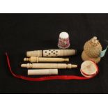 A porcelain thimble, four needle cases,