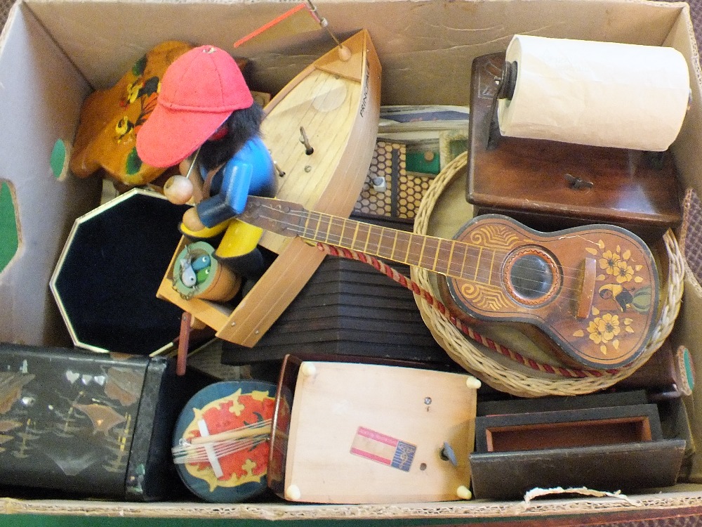 Various wooden and other music boxes in a wide variety of shapes