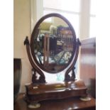 A Victorian mahogany oval swing toilet mirror