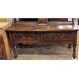 A late 18th Century oak sideboard on turned legs with two drawers and brass pierced handles and