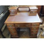 An Edwardian mahogany writing desk with brass gallery,