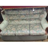 A modern blue floral upholstered three seat settee