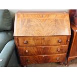 A Victorian flame mahogany three drawer bureau