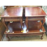 A pair of occasional tables and a mahogany finish coffee table all with drawers