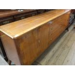 An elegant reproduction inlaid mahogany sideboard with central drawers flanked by two twin door