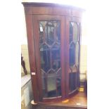 An Edwardian mahogany bow front corner cabinet