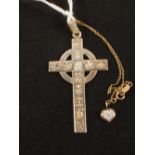 A Silver stylised cross pendant with a small Gold Diamond set pendant on chain
